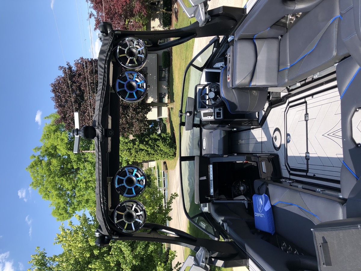 Wake boat tower with blue-lit Wet Sounds speakers